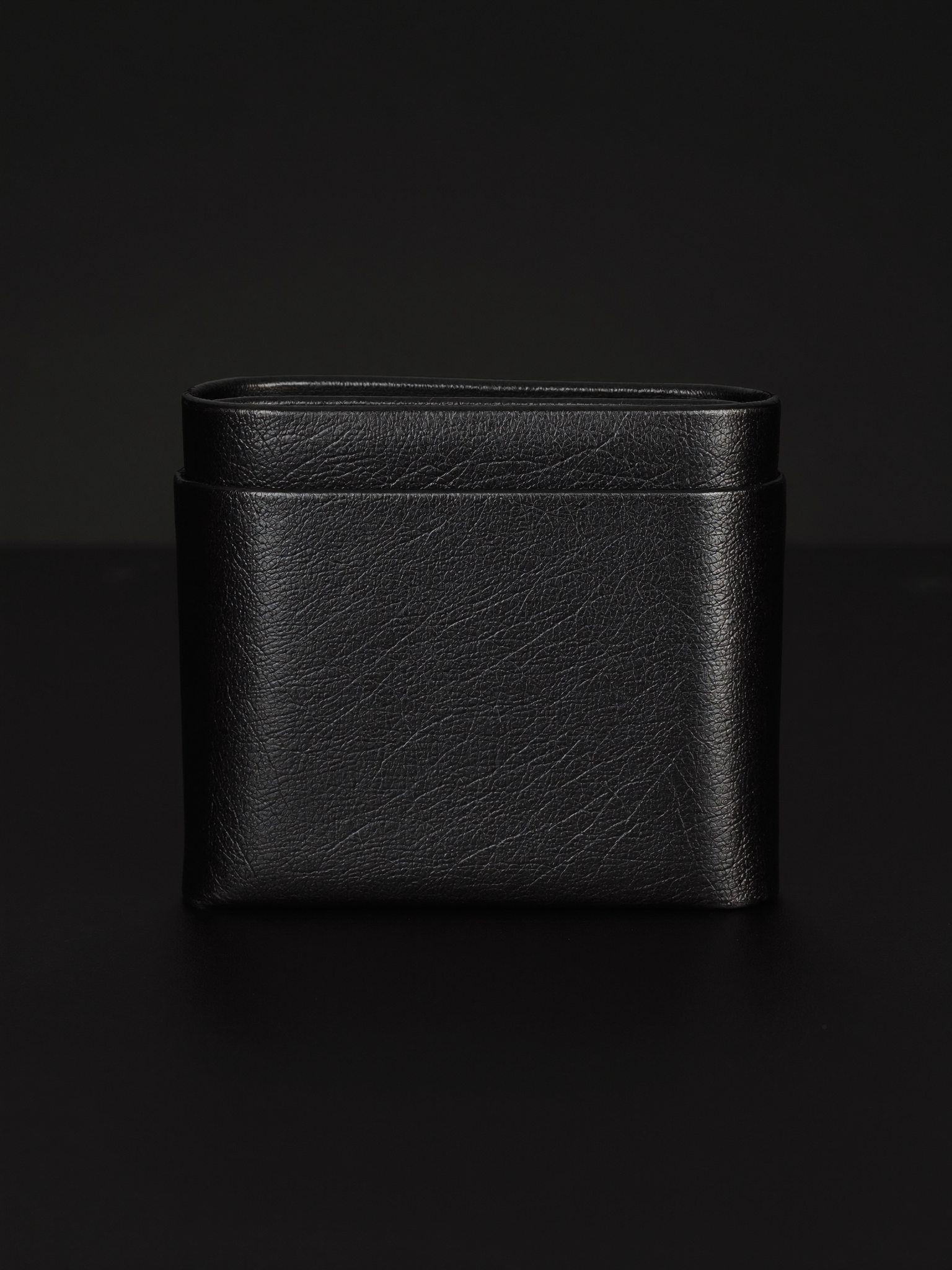 Black leather wallet on matte black